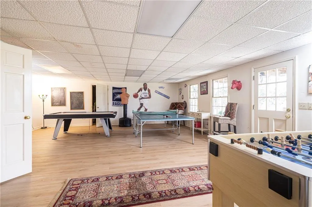 Game room featuring light wood-style flooring, a paneled ceiling, and billiards