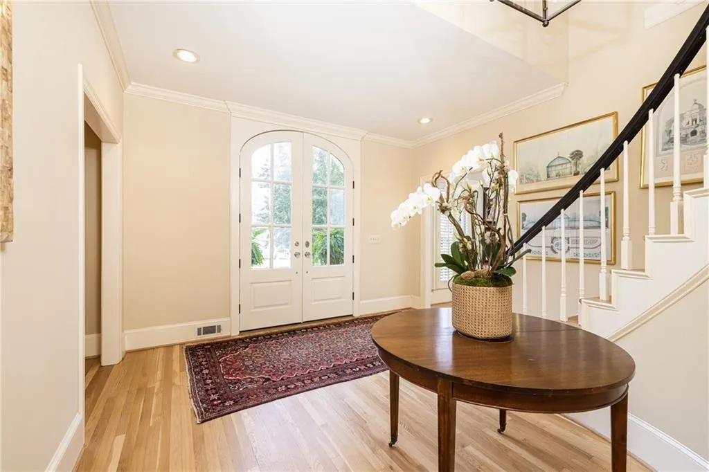 Entrance foyer featuring french doors, light wood-style flooring, crown molding, and recessed lighting