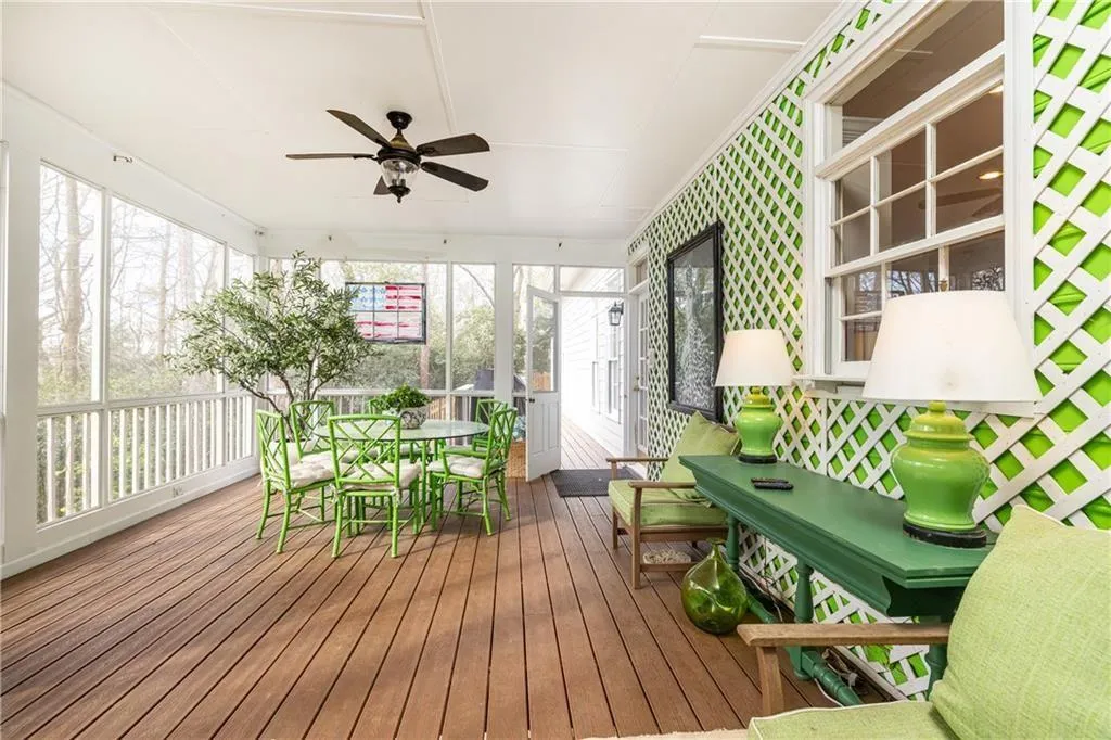 Sunroom featuring ceiling fan, outdoor dining space, and a deck