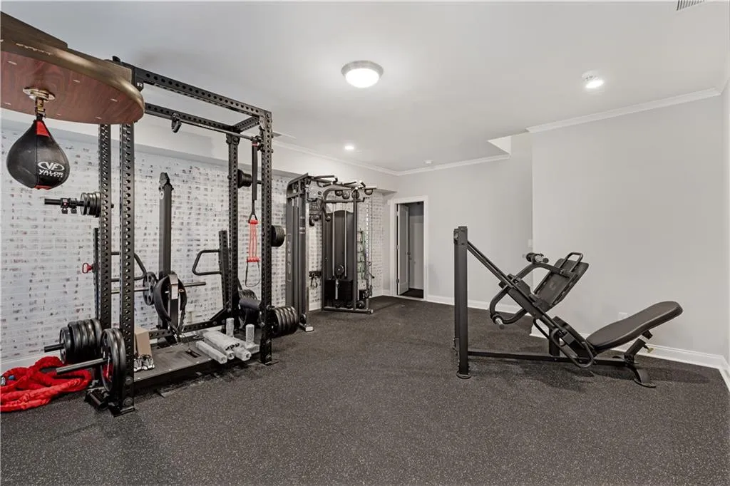 Workout room featuring crown molding