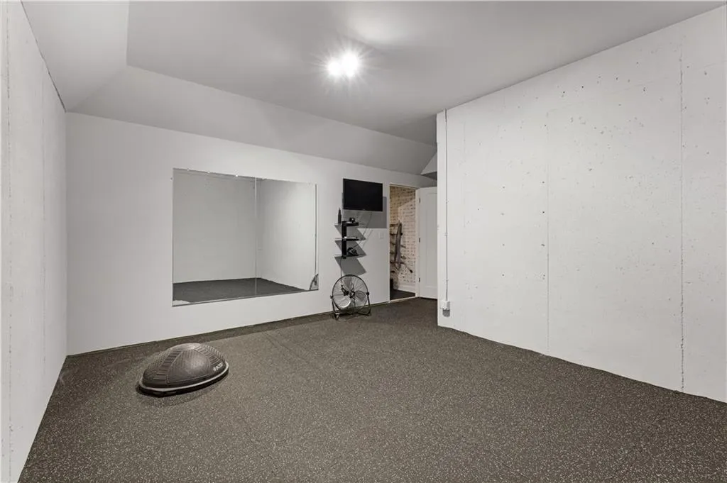 Empty room with lofted ceiling