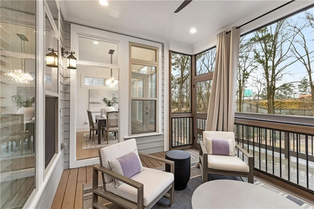 Sunroom / solarium featuring a water view