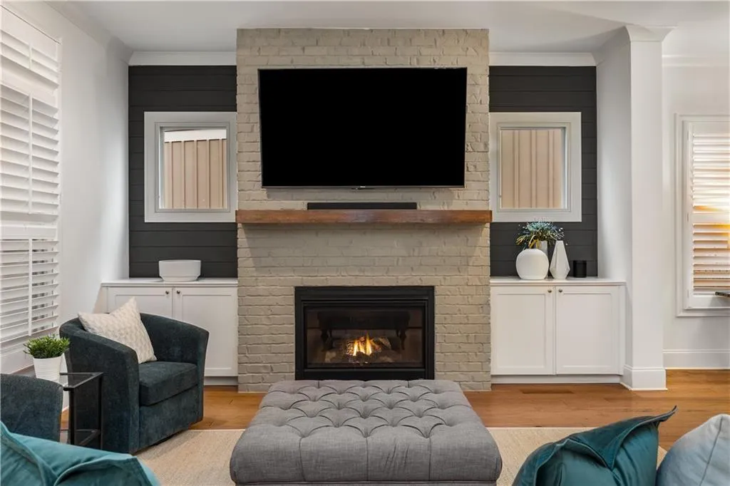 Living room features a brick fire place and built-ins for extra storage