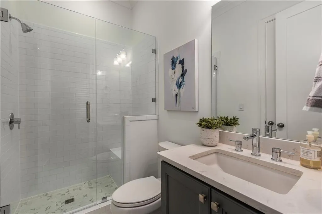 Bathroom featuring vanity, an enclosed shower