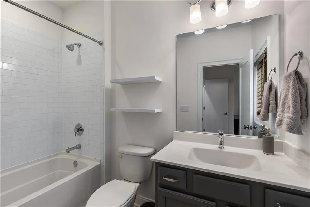 Full bathroom featuring vanity, tiled shower