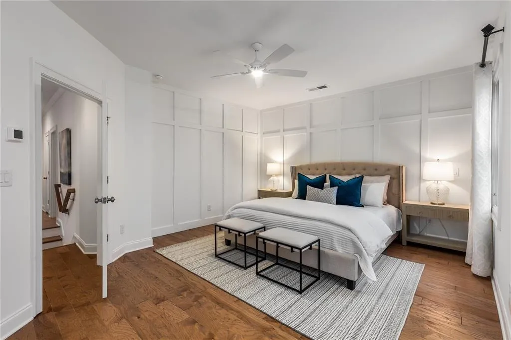 Spacious Bedroom featuring hardwood floors and ceiling fan.