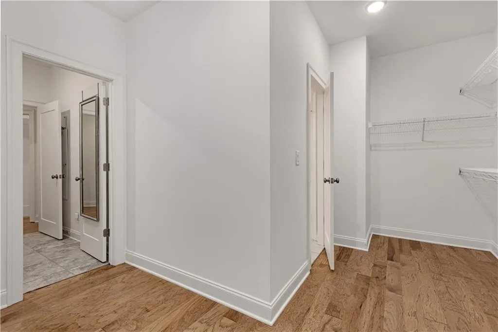 Corridor with light hardwood / wood-style flooring