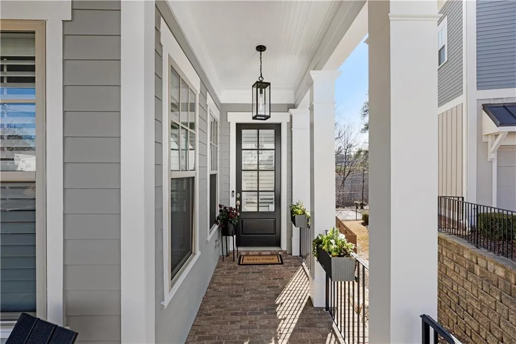 Inviting front porch with brick pavers and lantern lighting.