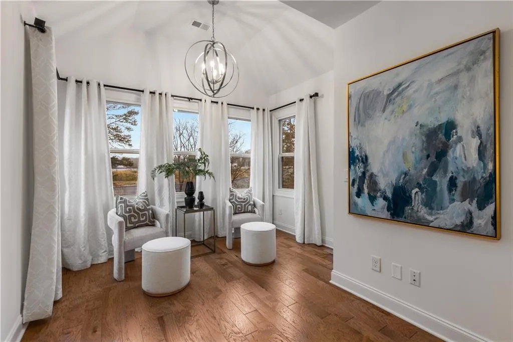 Enjoy some private time in your sitting room with an inviting chandelier, hardwood floors and vaulted ceiling