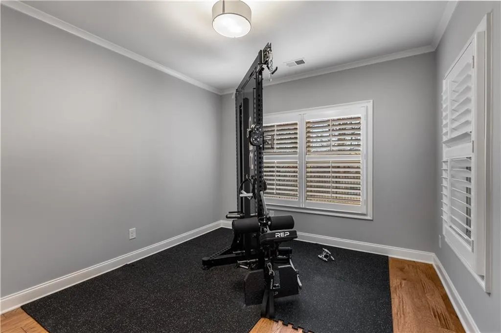 Workout room featuring crown molding