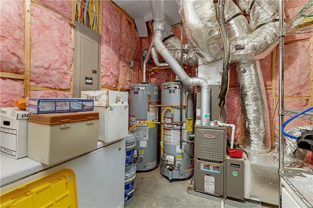 Utility room with gas water heater and electric panel