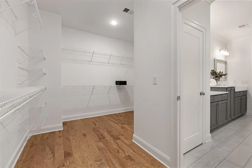 Walk in closet featuring light wood-type flooring