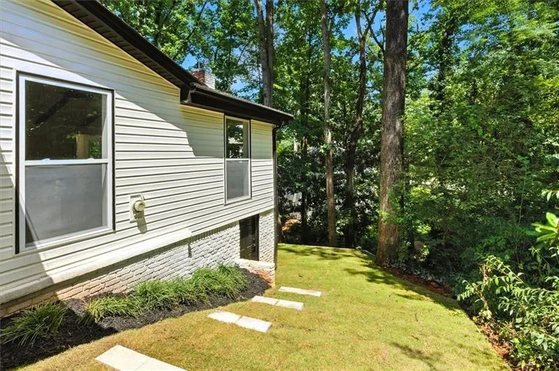 Side yard, w/ exterior entry storage room.