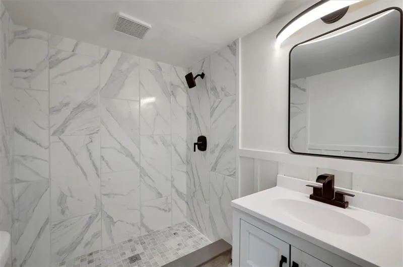 Walk-out basement/terrace level bedroom with sliding glass door to the side yard patio.