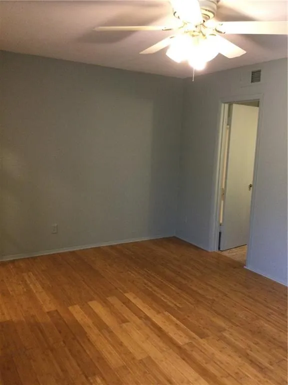 Spare room with light wood-type flooring and ceiling fan