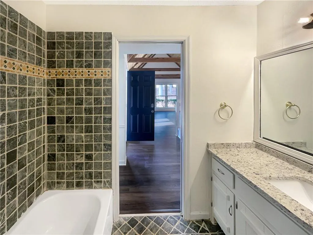 Bathroom with vanity and  shower combination