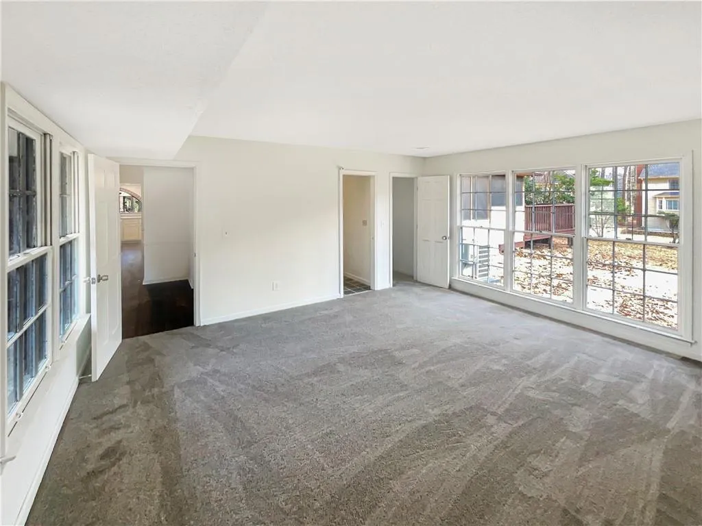 Unfurnished bedroom with carpet flooring and baseboards