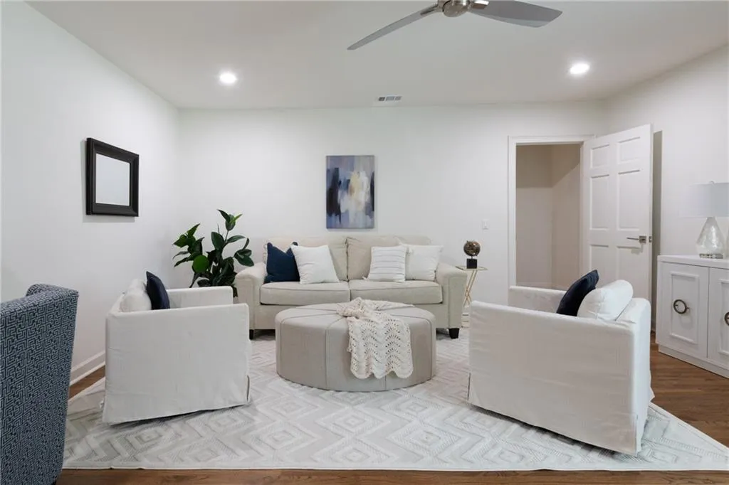 This upper-level 5th bedroom offers flexibility as a gaming room or home office, featuring plantation shutters, a spacious walk-in closet, separate cedar closet, and convenient backstairs leading to the kitchen - perfect for comfort, privacy, and functionality.