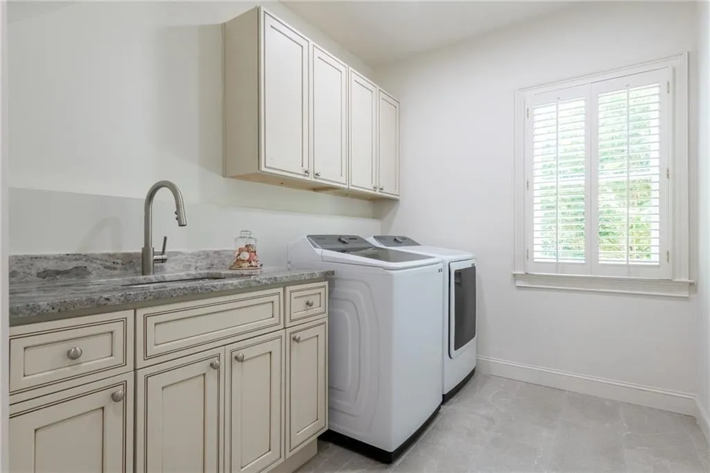 Laundry room on main level. New cabinets, sink, faucet and tile floor. There's a laundry room on the basement level to accommodate a full-size washer and dryer.
