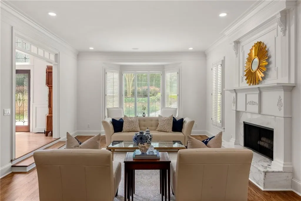SStep into your living room with wood plantation shutters and view towards the foyer.