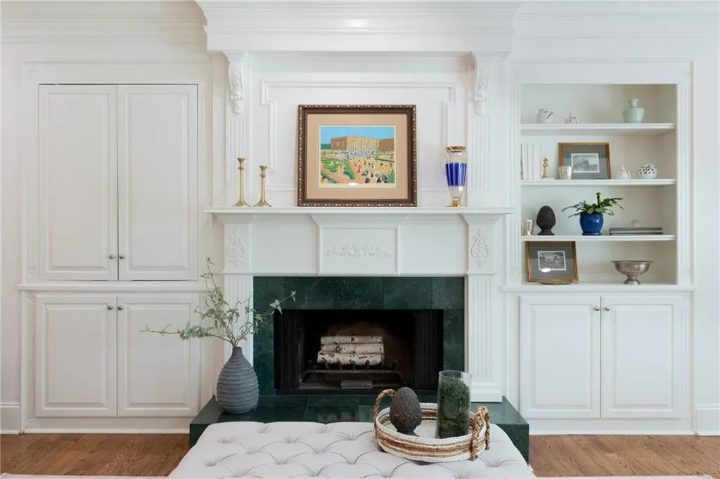 The cabinetry provides both storage and display space, while integrated whole-home audio equipment ensures seamless entertainment throughout the room.
