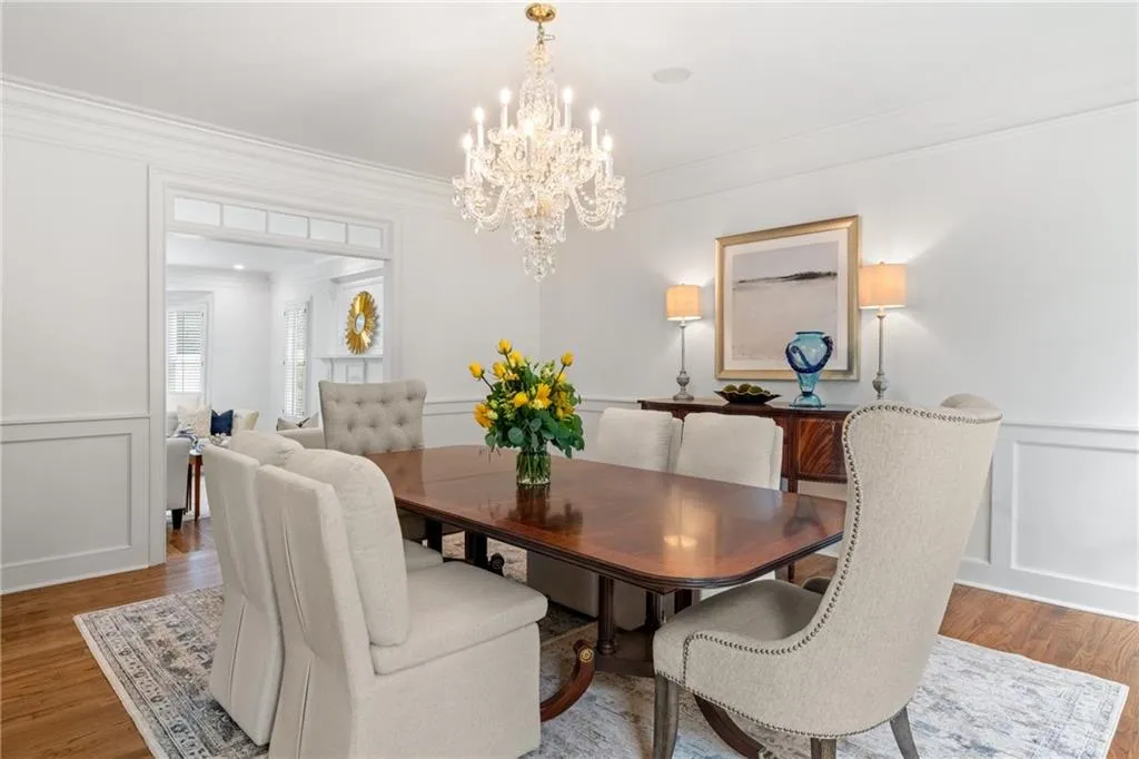 The dining room flows seamlessly into the formal living room, creating an effortless transition from elegant dining to relaxed entertaining.
