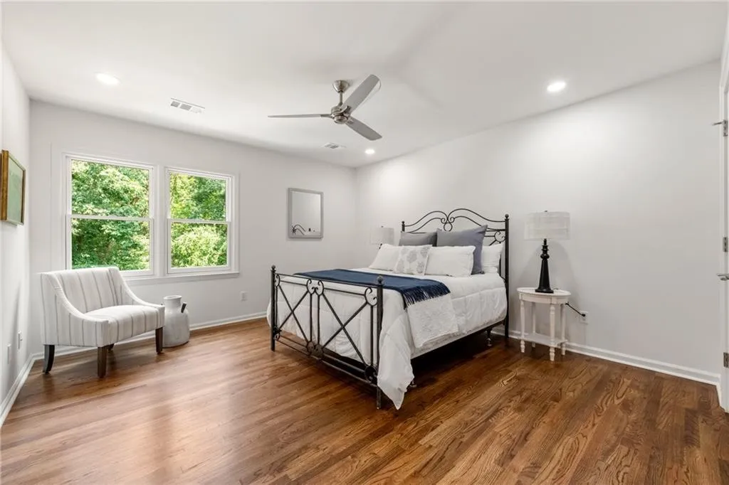 One of four spacious secondary bedrooms on the upper level, this room is part of a Jack-and-Jill configuration. Generously sized, it easily accommodates any bed plus additional furniture. All secondary bedrooms in the home feature Elfa shelving systems, offering versatile storage and organization.