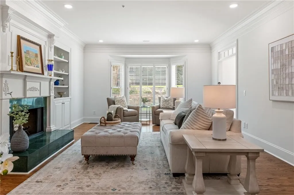 This family room exudes comfort and style, showcasing a gas-starter fireplace framed with elegant built-ins and rich detailing.