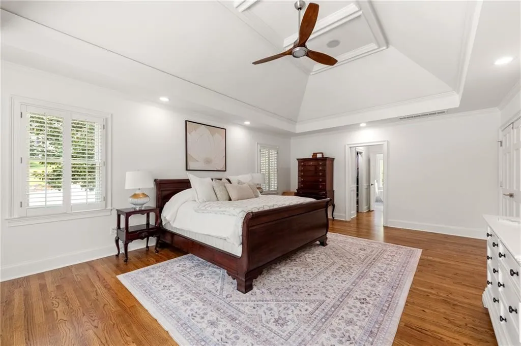 Primary bedroom with views toward the walk-in closets and bath, separated by a pocket door for added privacy and convenience.