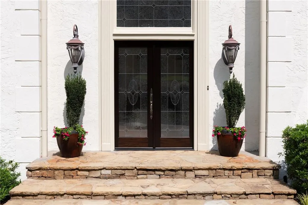 Greet family and friends at your new solid double mahogany doors with custom lead glass windows and decorative Baldwin mortise lock.