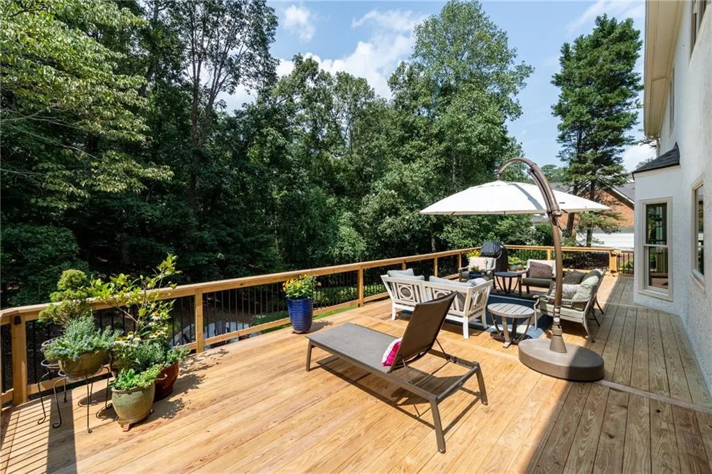 The new 16' x 44' deck provides ample space for multiple outdoor living areas, entertaining, and gardening. Outdoor post lighting integrates seamlessly with the property's overall lighting, while views of the private backyard, mature trees, and paver patio with stone fire-pit complete this inviting retreat.