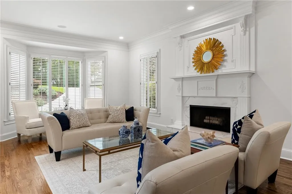 Spacious living room with Pella windows, abundant natural light, elegant fireplace, and inviting layout for both relaxation and entertaining.