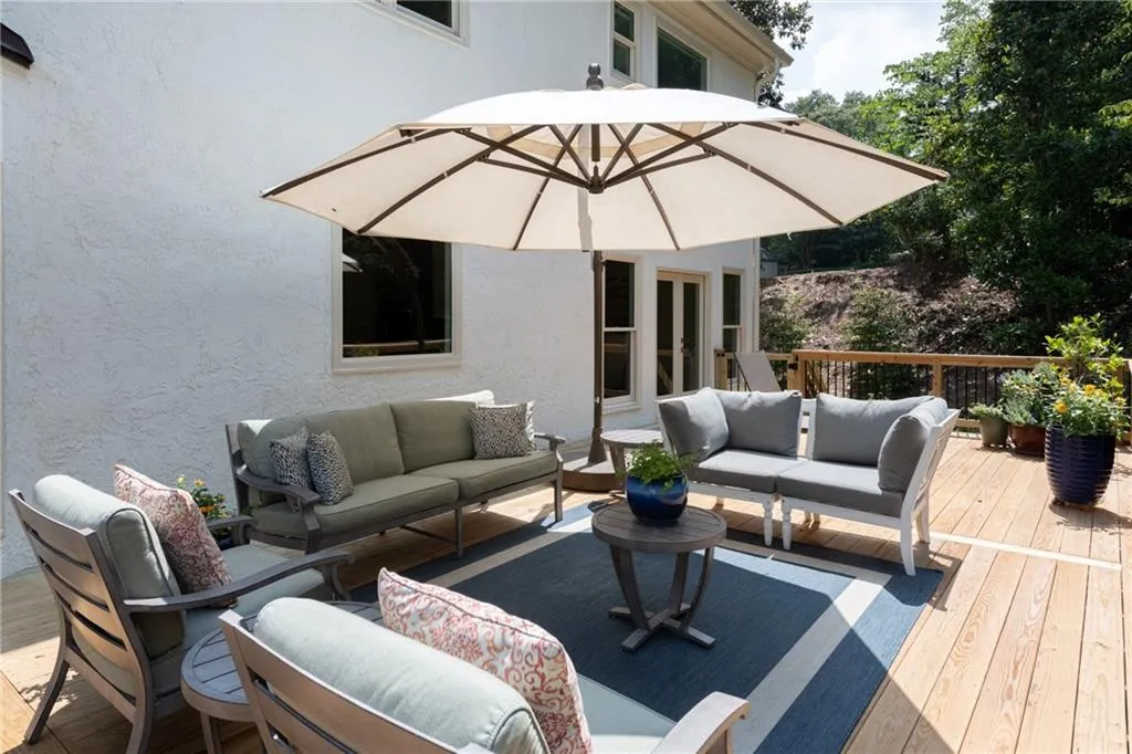 Window in the background is over the kitchen sink and double doors lead to formal dining room. You have ingress/egress from both sides of the deck to the lower level paver patio or backyard.