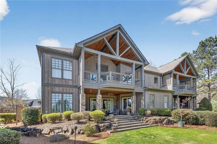 View of home  featuring stone and board and batten siding.