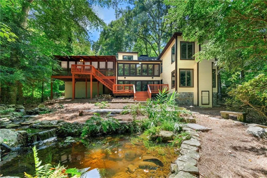 Lush greenery surrounds water feature with waterfall