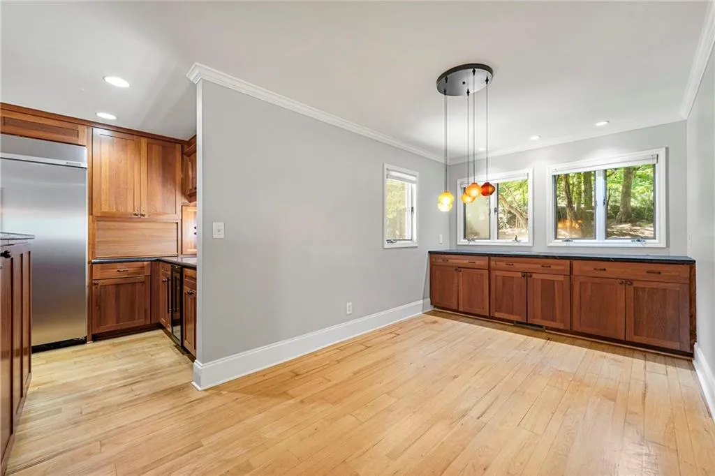 Breakfast area with wall of casement windows and lots of extra cabinets
