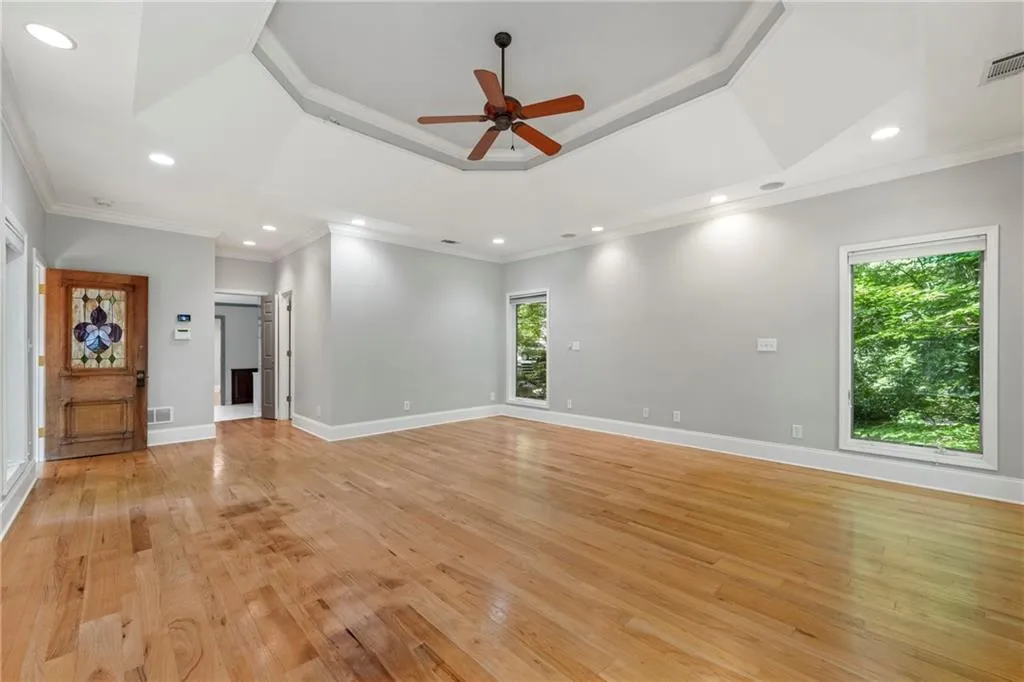 Primary bedroom features Trey ceiling and adorable door with stained glass inset.