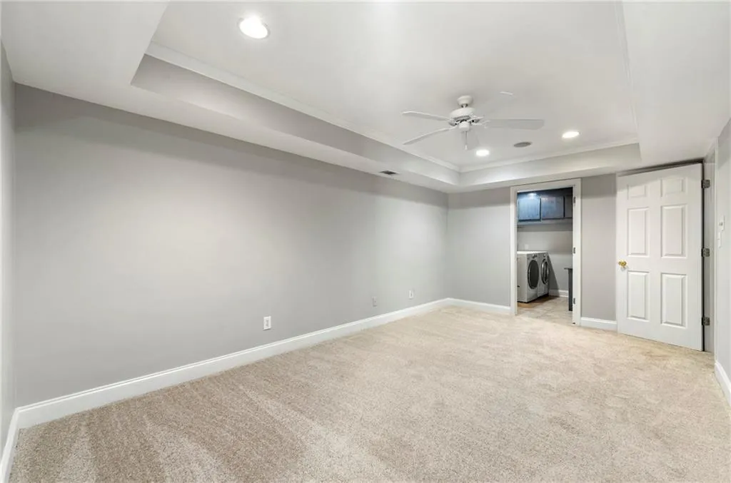 Bonus room in basement with trey ceilings.