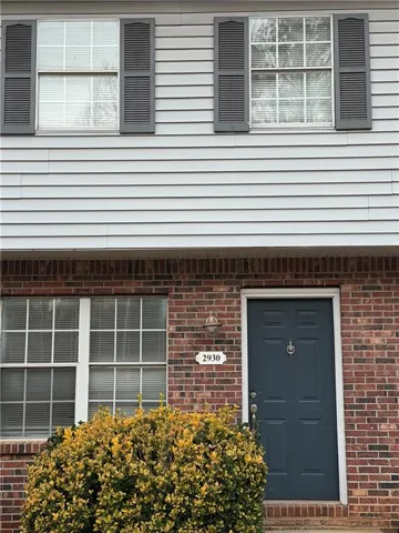 View of exterior entry featuring brick siding