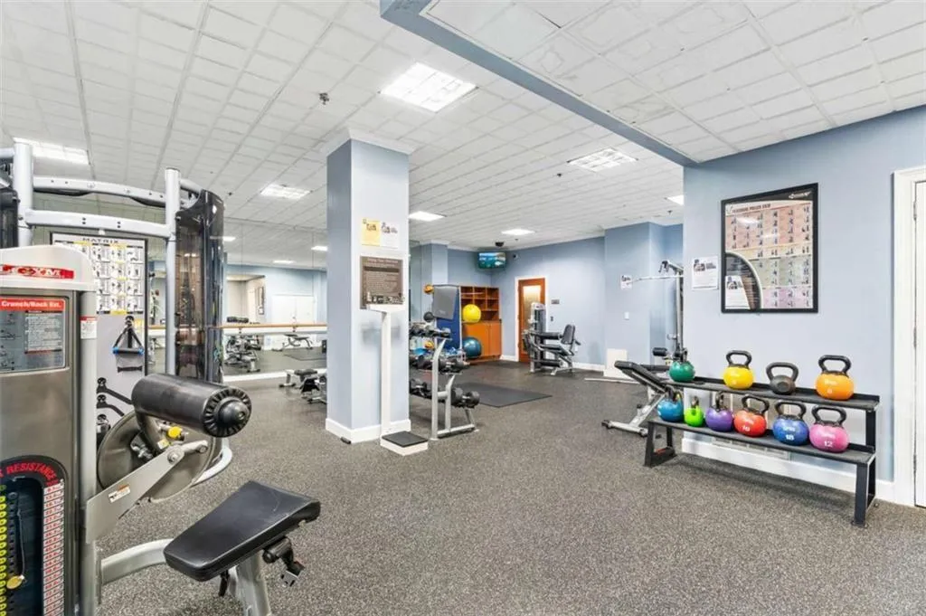 Exercise room featuring baseboards and a paneled ceiling