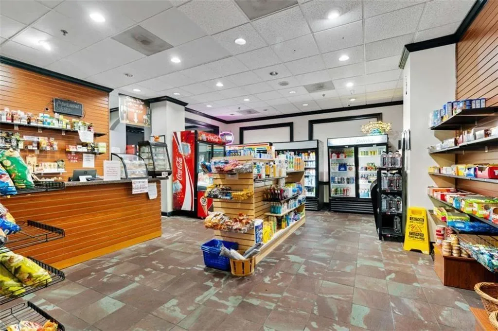 Welcome area featuring a drop ceiling, recessed lighting, and wooden walls