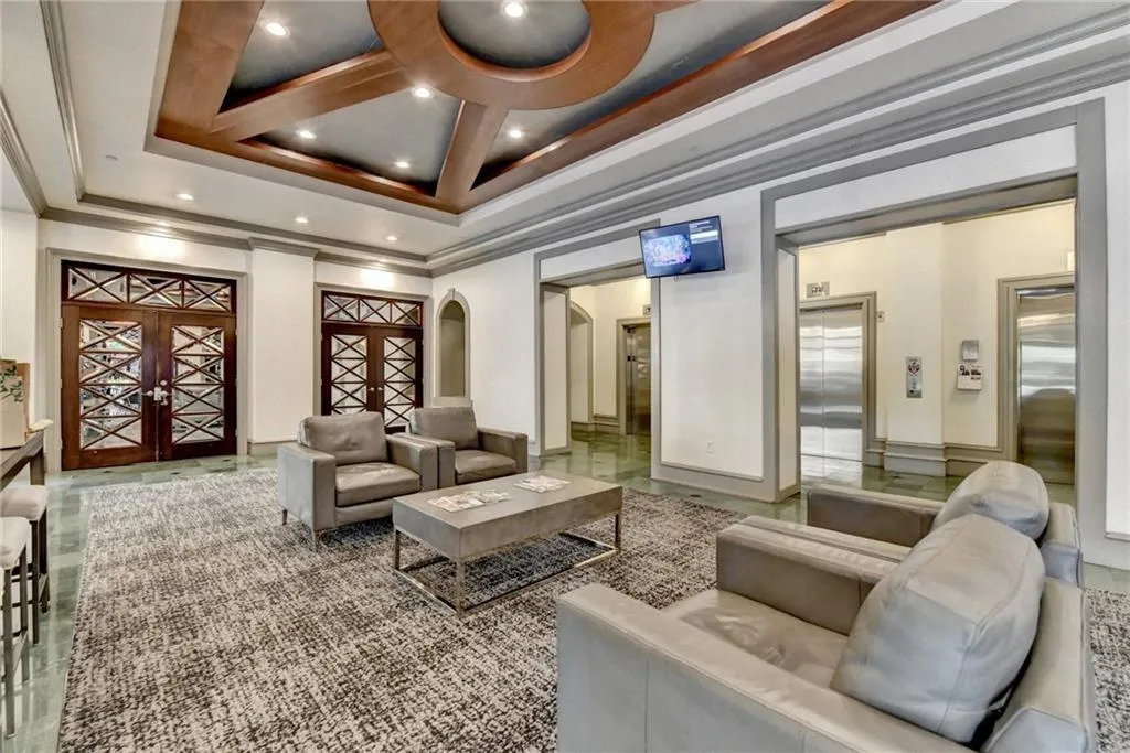 Common area with ornamental molding and recessed lighting