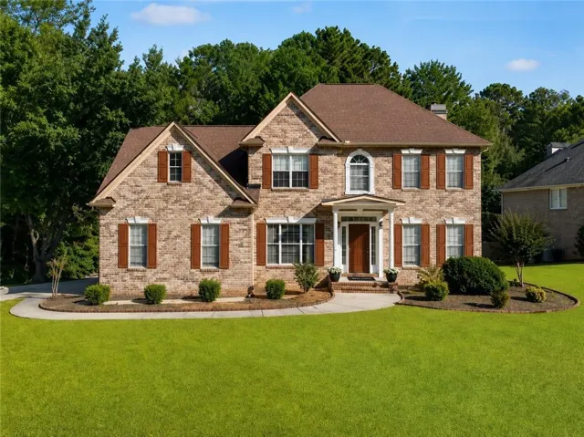Brick exterior with gabled roof lines and a prominent arched window