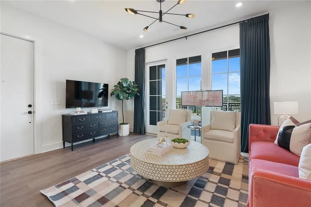 Living area with a chandelier, wood finished floors, and recessed lighting