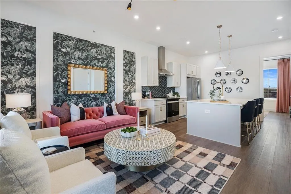 Living area with wood finished floors, recessed lighting, and wallpapered walls