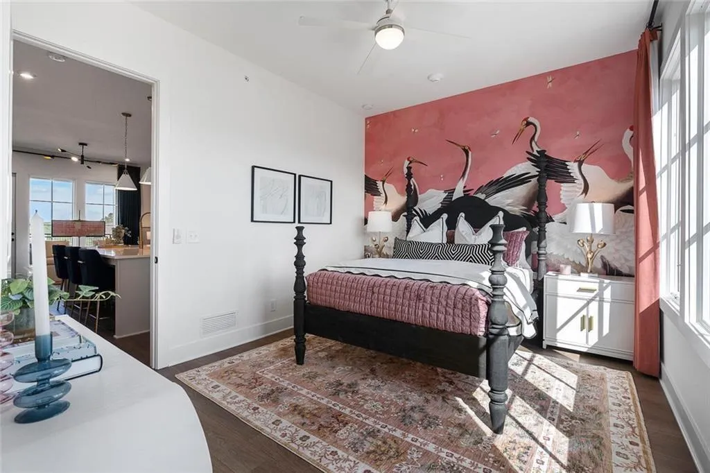 Bedroom with wood finished floors, access to outside, and a ceiling fan