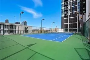 View of tennis court/pickleball with community basketball court