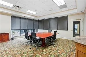 Community office featuring a drop ceiling