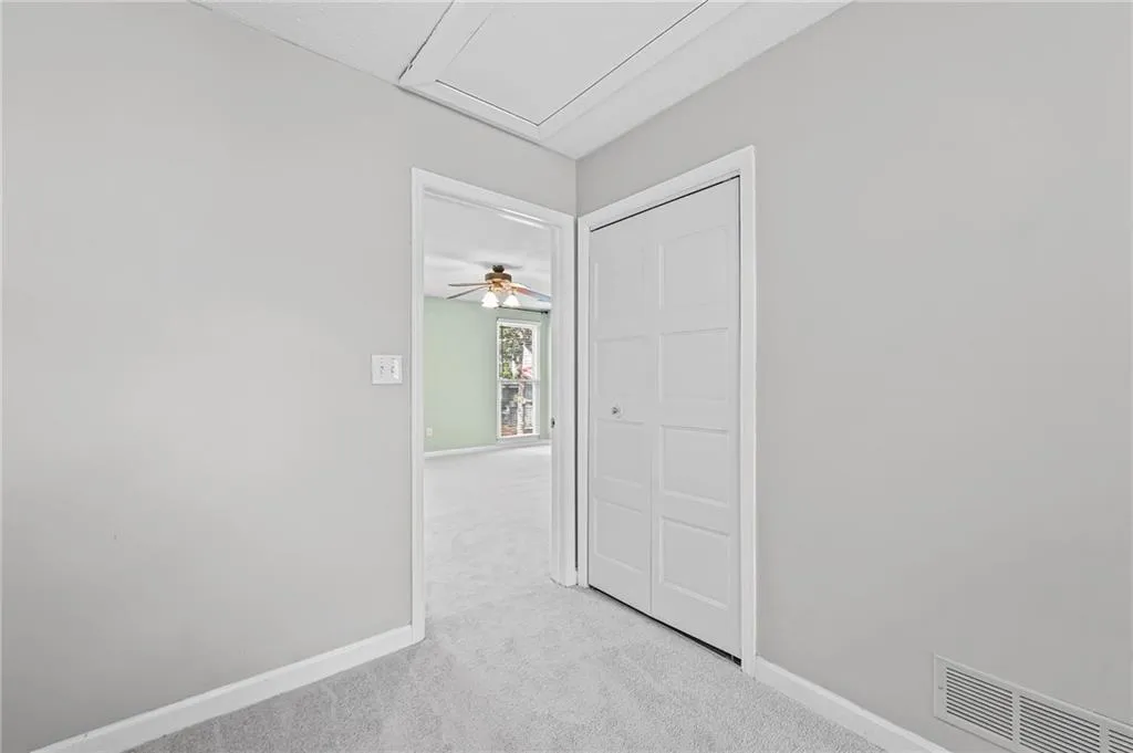 Spare room featuring light colored carpet and baseboards