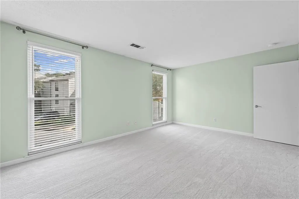 Spare room with light colored carpet